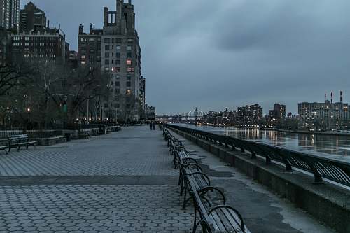 carl schurz park empty park in front body of water surrounded with buildings city